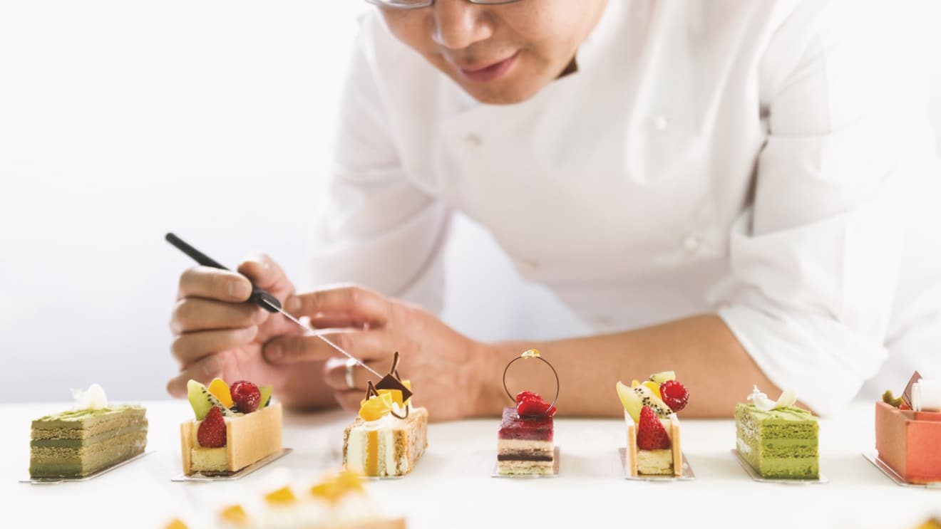 Chef putting finishing touches to desserts